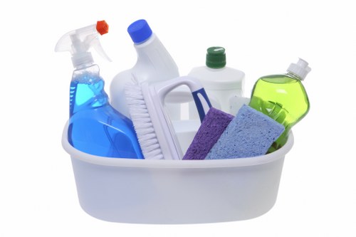 Professional cleaner maintaining desks and meeting spaces in W10 office