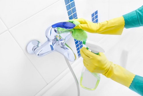 Cleaning operative using PPE during carpet cleaning work